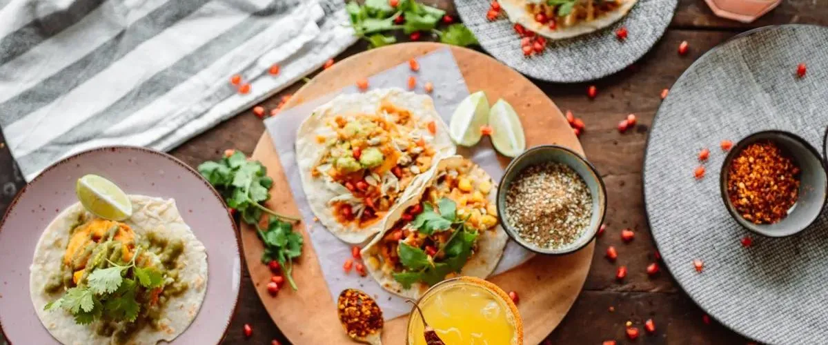 A table spread of tacos, burritos and sides — illustrative photo